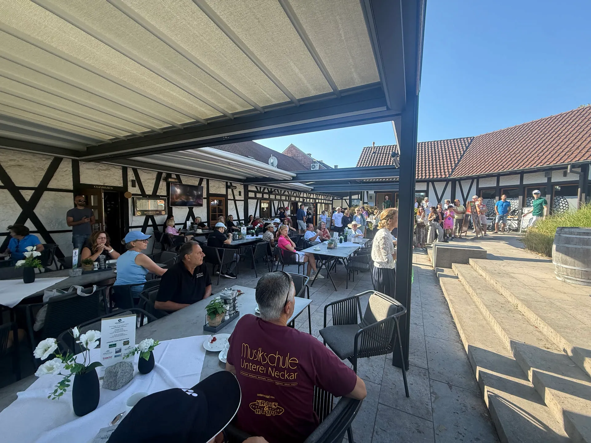 Gäste auf der Terrasse des Clubhauses